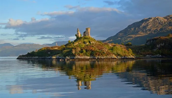 The crumbling stone ruins of Caisteal Maol overlooking the water on the Isle of Skye, Scotland.