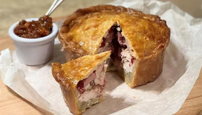 A rustic, artisanal venison and redcurrant pie baked fresh at Ludlow Farm Shop in Shropshire.